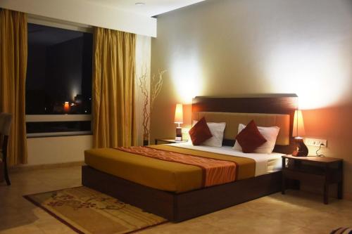 a hotel room with a bed and a window at Dew Drops Boutique Retreat in Igatpuri