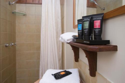 a bathroom with a shelf with some books on it at Milkwood Lodge in Cooktown