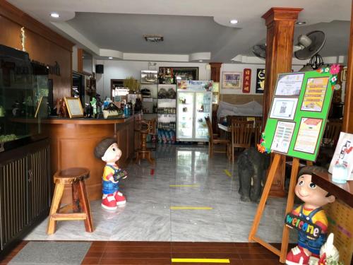 a room with two dolls standing in a kitchen at Hugpua Hotel in Nan