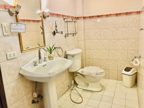a bathroom with a sink and a toilet at Dolce Vita Hotel in Puerto Princesa City