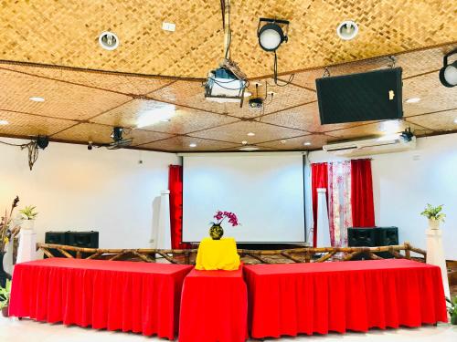 a room with two red tables with a yellow person sitting on top at Dolce Vita Hotel in Puerto Princesa City
