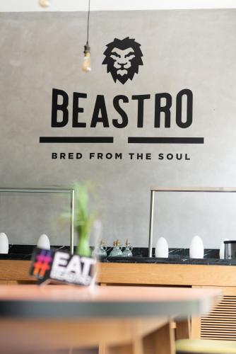 a sign for a restaurant with a beastro sign on the wall at First Central Hotel Suites in Dubai