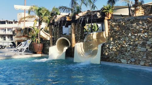 a water slide in a pool at a resort at Hotel Alba Seleqtta in Lloret de Mar