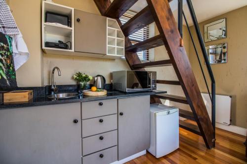 a kitchen in a tiny house with a ladder at Craigivar Guesthouse in Pretoria