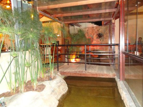 a room with a pool of water with plants in it at Pousada Bon Vivant in Cabo Frio