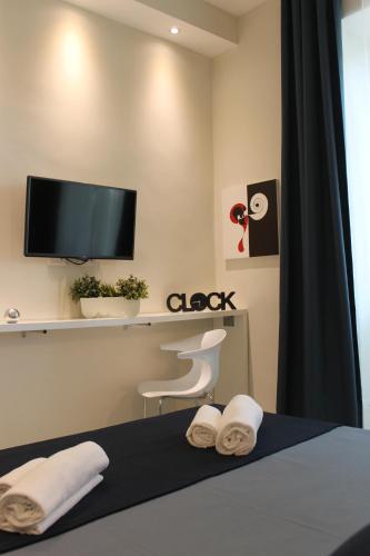 a bedroom with a bed with a tv on the wall at Little Rose Lodge in Rome