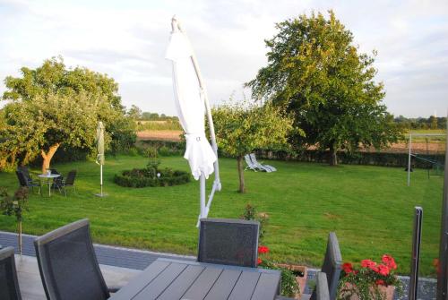 a white umbrella sitting on top of a table at Ferienwohnung Wackerballig in Gelting