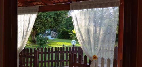 a view of a yard through a window with a fence at B&B Leonida in Taranto