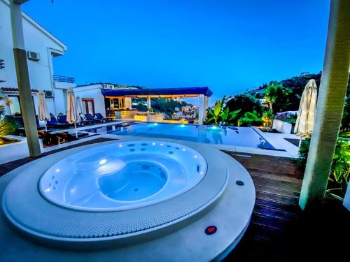 a hot tub sitting on a deck next to a pool at Apartments Secret Garden in Ulcinj