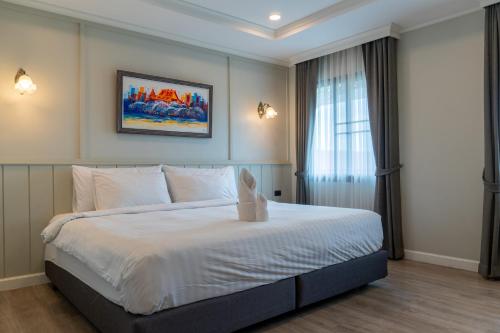 Una cama o camas en una habitación de Rimwiang