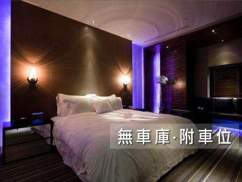 a hotel room with a bed and a night stand at Wego Funtel - Dazhi Branch in Taipei