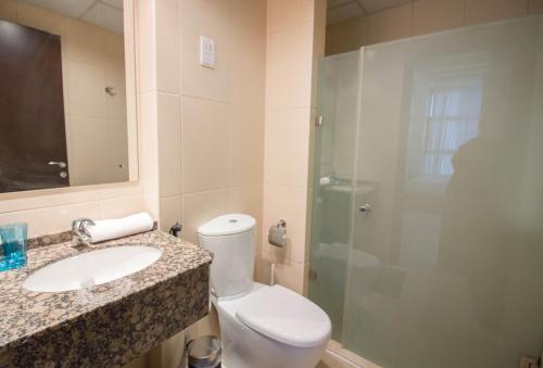 a bathroom with a toilet and a sink and a shower at Spacious Studio - Sports city - Diamond in Dubai