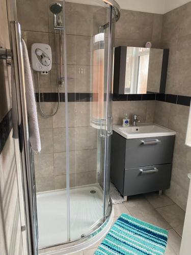 a bathroom with a shower and a sink at The Silverdale . in Farnborough