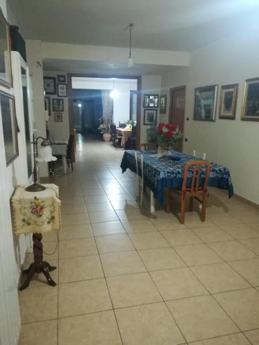 a living room with a table and a dining room at Villa Linda Bed And Breakfast in Sulmona