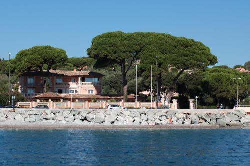 a house on the shore of a body of water at Hotel Martinengo in Sainte-Maxime