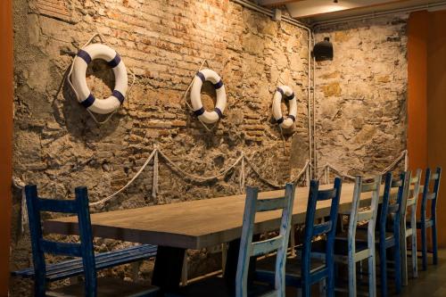 a dining room with a wooden table and chairs at BcnSportHostels in Barcelona
