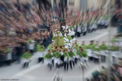 a crowd of people walking down a street with a parade at Villa Linda Bed And Breakfast in Sulmona
