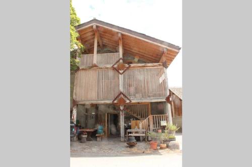 a large wooden building with a balcony on it at La Chujale in Arbaz