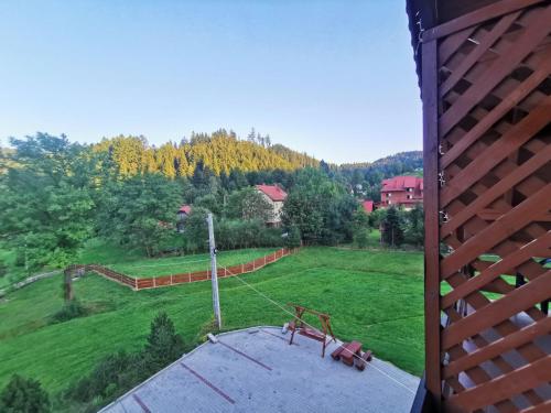 a view of a green field with a playground at Noclegi "Na Szczyrboku" Dom II in Korbielów