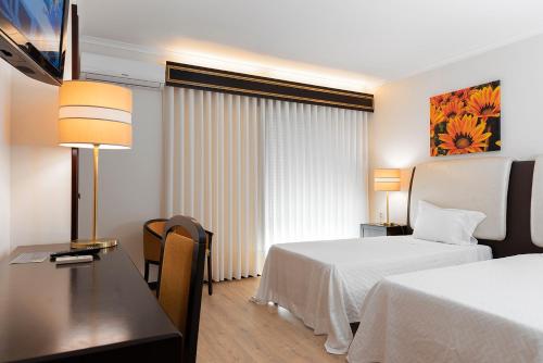 Ένα ή περισσότερα κρεβάτια σε δωμάτιο στο Hotel Jardim