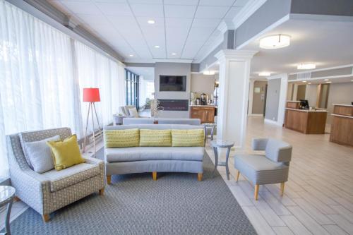 a living room with two chairs and a couch at Holiday Inn Bloomington Airport South-Mall Area by IHG in Bloomington