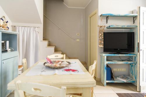 a dining room with a table and a tv at Cà Tabachera in Rimini