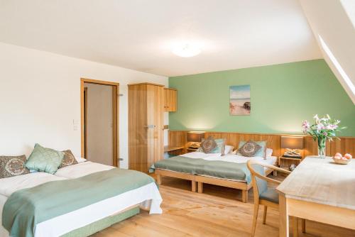 a hotel room with two beds and a table at Ökotel Hamburg in Hamburg