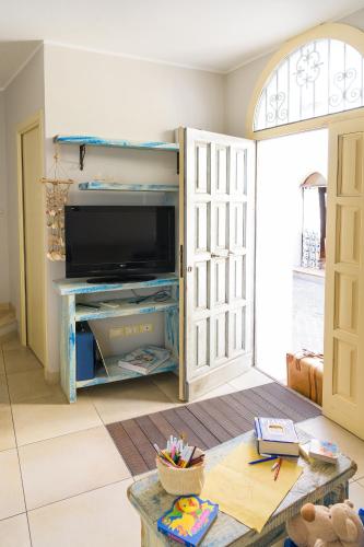 a living room with a television and a table at Cà Tabachera in Rimini