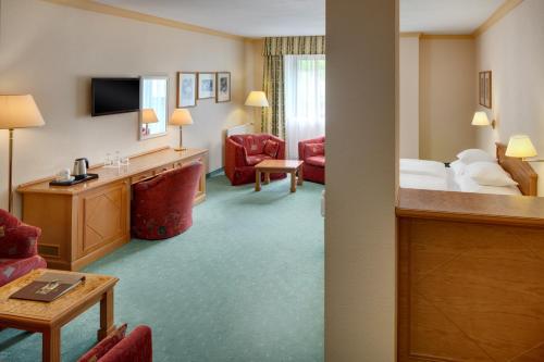a hotel room with a bed and a television at Ensana Butterfly in Mariánské Lázně