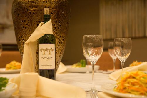 a bottle of wine sitting on a table with two glasses at Holiday Inn Murfreesboro by IHG in Murfreesboro