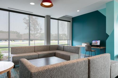 a living room with a couch and a table at Avid Hotels - Roseville - Minneapolis North by IHG in Roseville