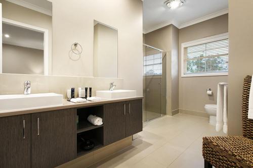 a bathroom with two sinks and a mirror at Kerami Manor & Day Spa in Marysville