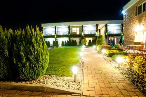 a garden at night with lights in the grass at Apartmán Lenka in Veľký Meder