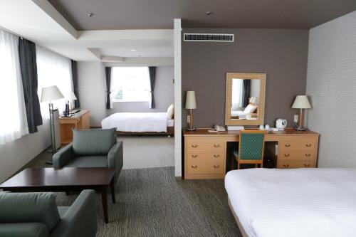 En eller flere senger på et rom på Hotel Premium Green Hills