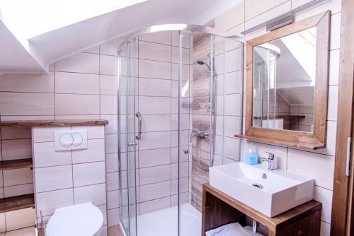 a bathroom with a sink and a shower at Három a Kislány Panzió in Hévíz