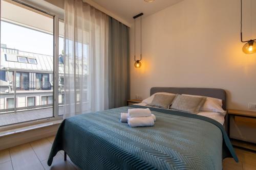 Posteľ alebo postele v izbe v ubytovaní VIP Apartamenty Butikowa