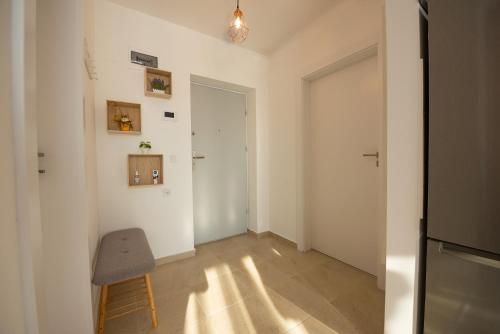 an empty room with a chair and a door at ART Apartment in Târgu-Mureş