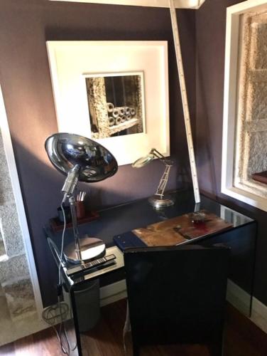 a room with a desk with a lamp on it at Enoturismo Novavila Rias Baixas Wine Design in Meis