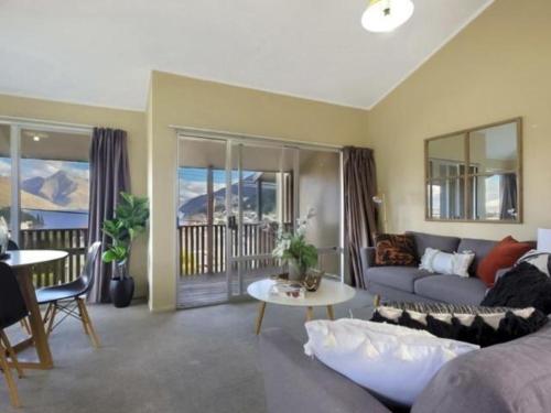 a living room with a couch and a table at ULTIMATE CONVENIENCE, WALK-TO-TOWN TOWNHOUSE in Queenstown