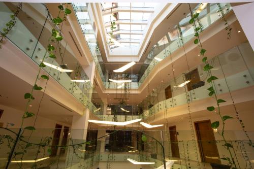 a building with a spiral staircase with plants at Best Western Premier Ark Hotel in Tirana