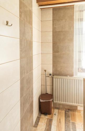 a bathroom with a toilet in the corner of a room at Fortuna Vendégház in Kiskunhalas