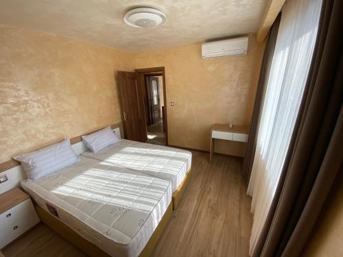 a small bedroom with a bed and a window at Coziness and comfort in the Old Town in Veliko Tŭrnovo