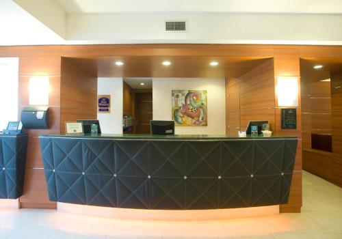 a lobby with a black counter in a building at Hotel Master in Brescia