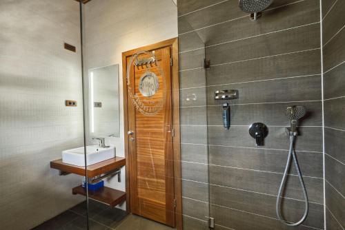 a bathroom with a shower with a clock on the wall at Vogue Boat Apartments in Budapest
