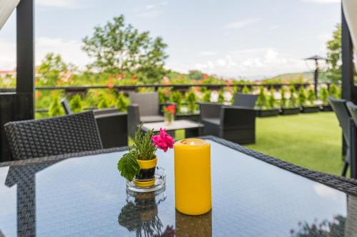 a table with a candle and a flower on it at Casa Moritz in Braşov