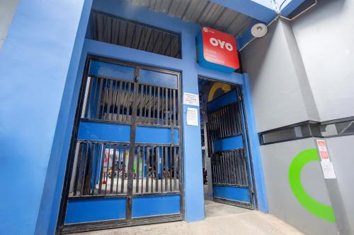 a blue building with doors with a qo sign at OYO 3728 Tunas Plaza Residence in Bekasi
