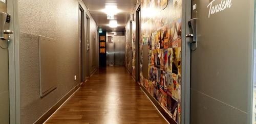 a hallway with a long aisle with posters on the walls at hotelF1 Paris Gennevilliers, 4 Rue Georges Corète 92230 Gennevilliers in Gennevilliers