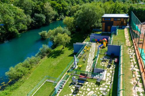 an aerial view of a train ride next to a river at Hotel RIO VERDE in Podgorica