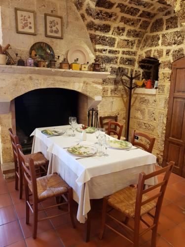 a dining room with a white table and chairs at Tenuta Patruno Perniola in Gioia del Colle
