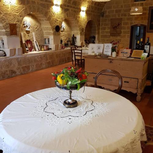 a table with a bowl of fruit on top of it at Tenuta Patruno Perniola in Gioia del Colle